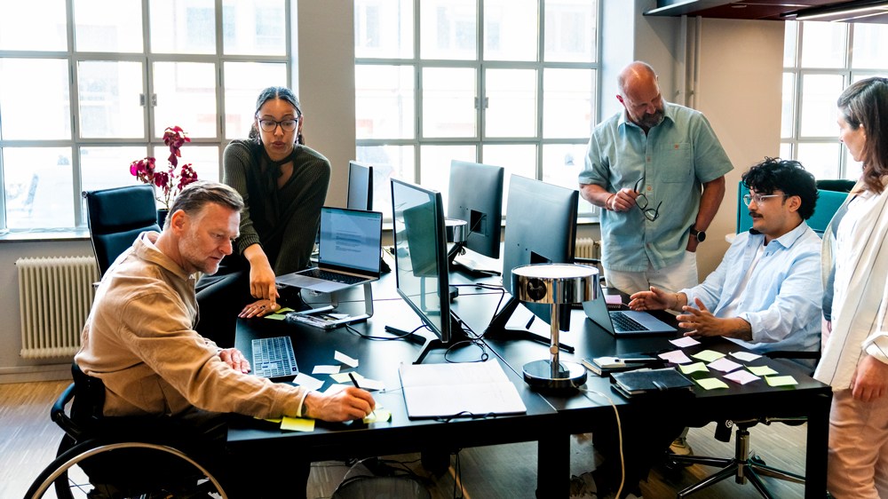 busy team at open work table with computers