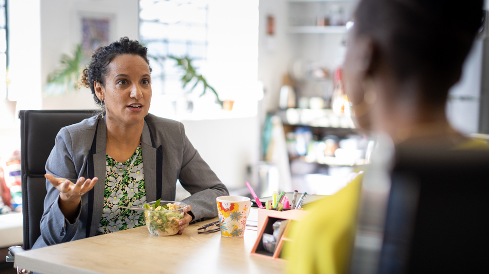 woman showing frustration with boss in office