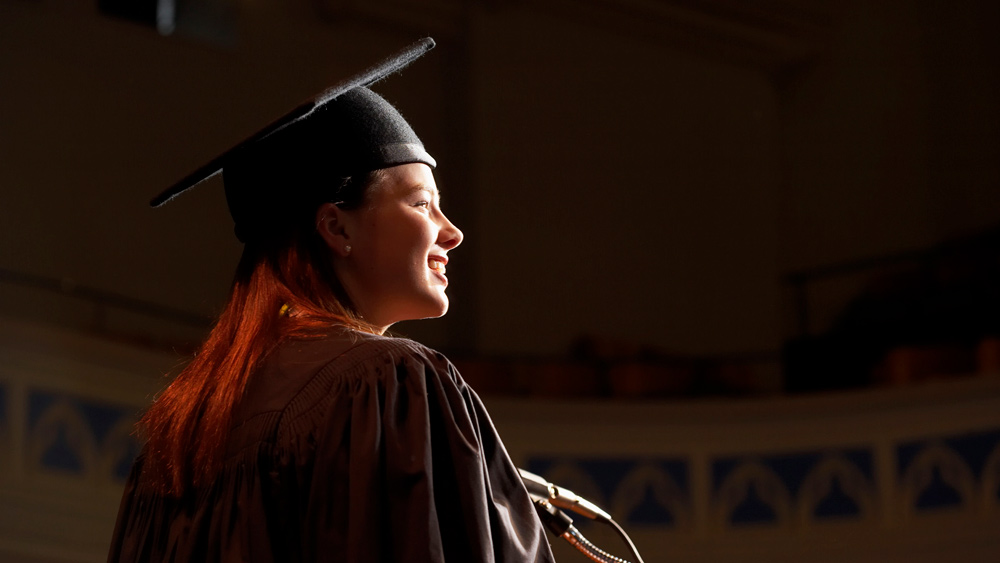 woman giving speech at graduation