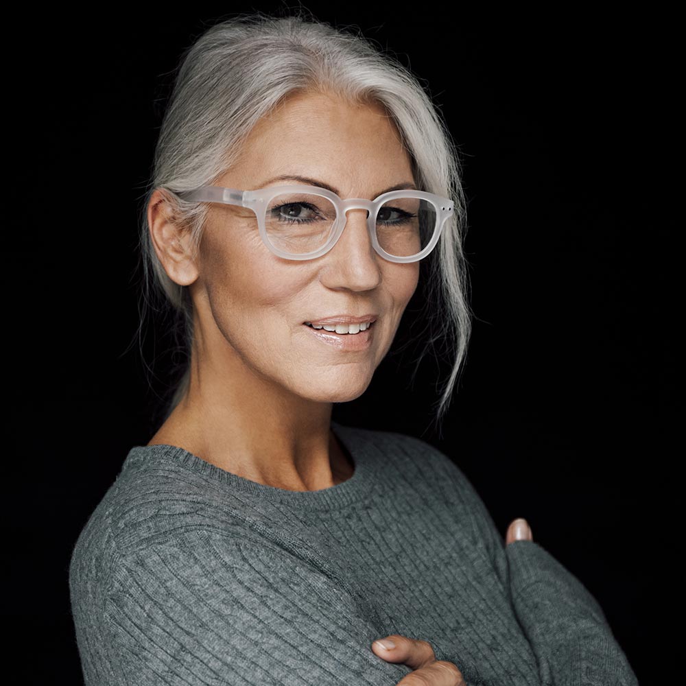 Professional Woman with Grey hair and glasses headshot