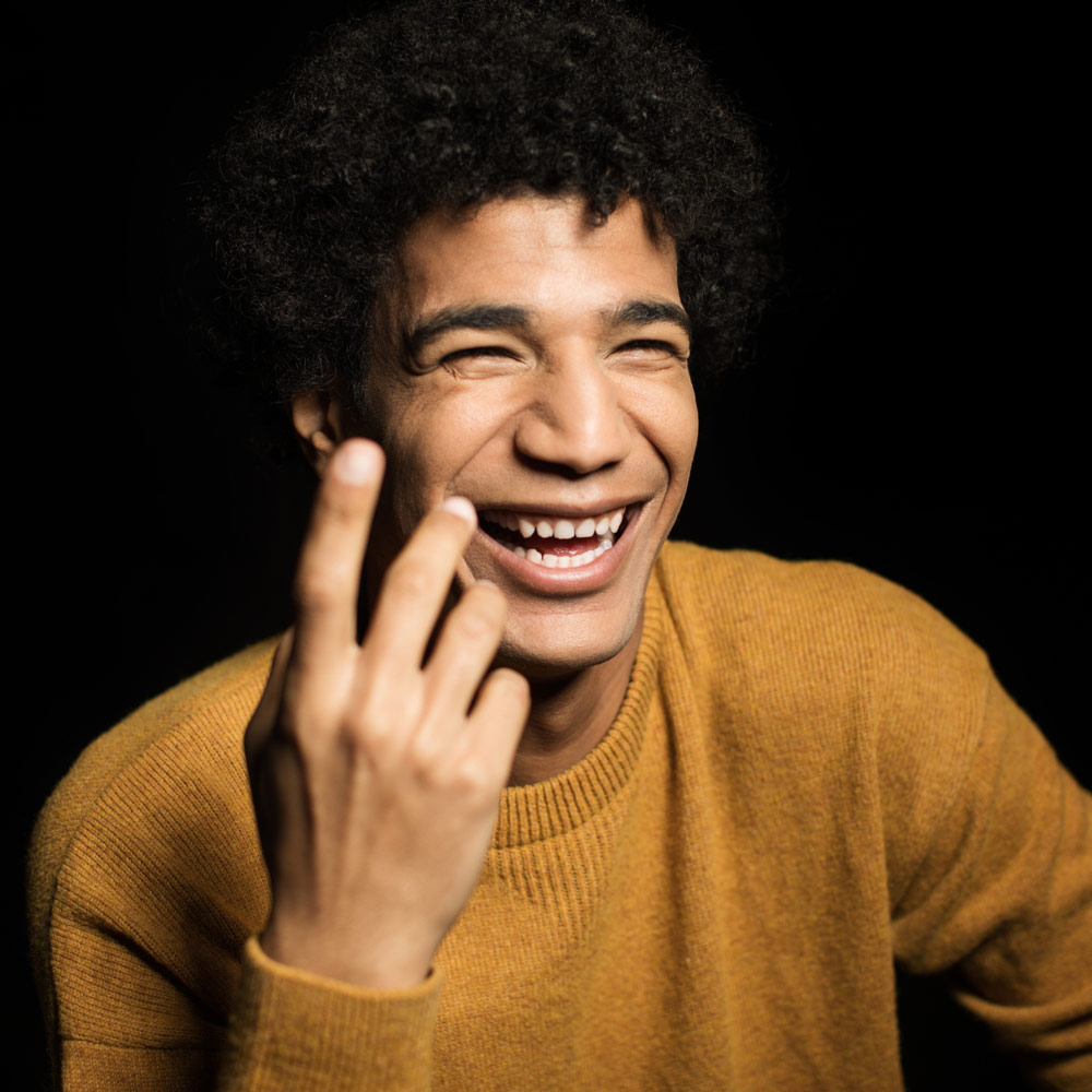 Man Laughing with yellow sweater Headshot