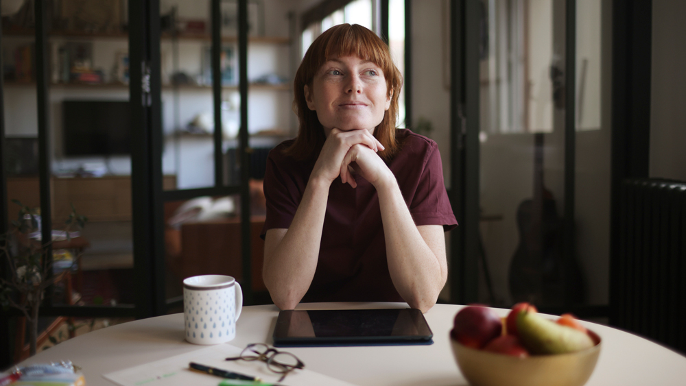 redheaded woman at home feeling at peace