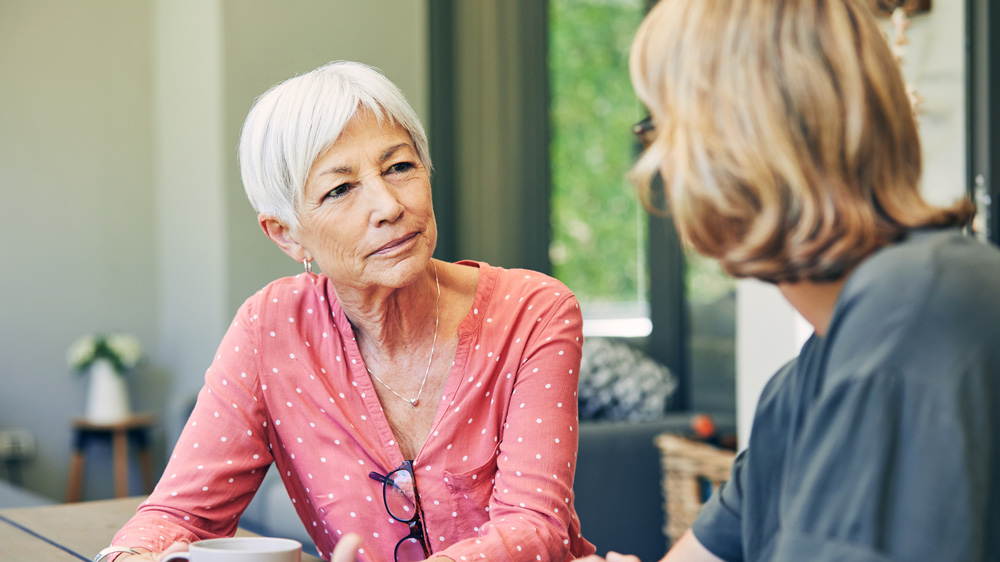 senior woman talking with a young adult woman