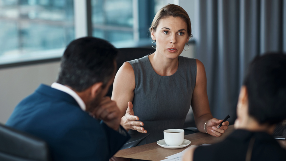 woman in office having a serious conversation with peers