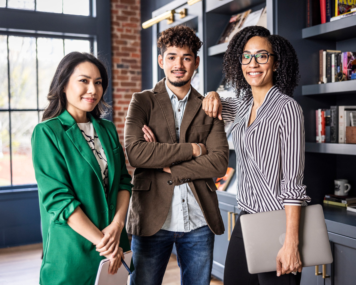 trio of young leaders standing confidently together