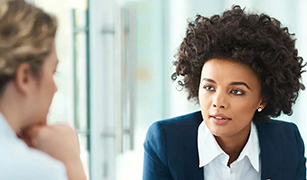 two women in office having accountability conversation