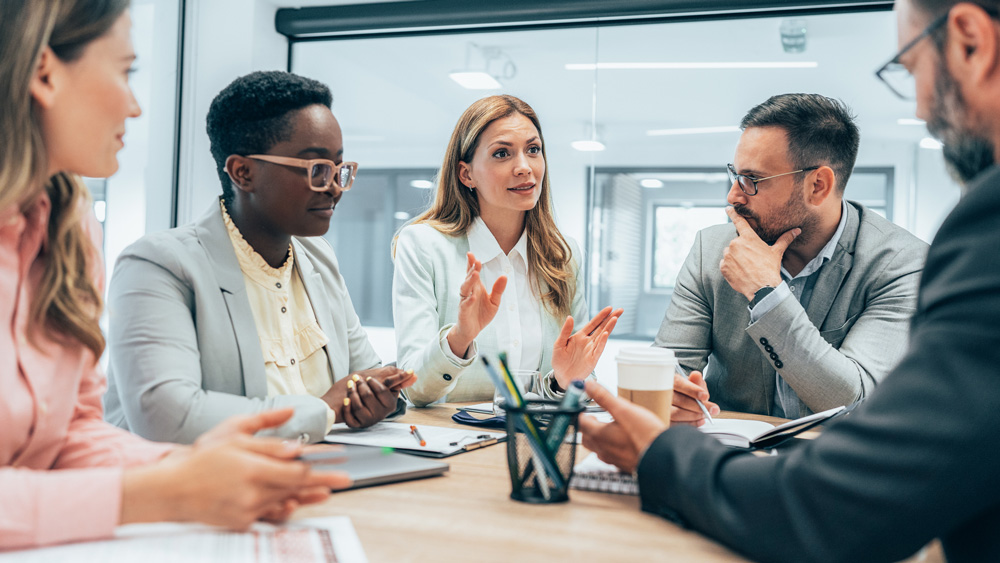 group of leaders brainstorming at office table