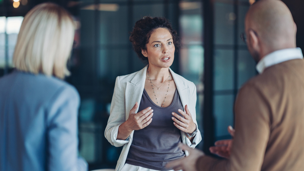 Businesswoman arguing with colleagues
