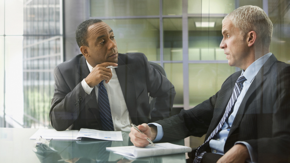 two businessmen having serious conversation