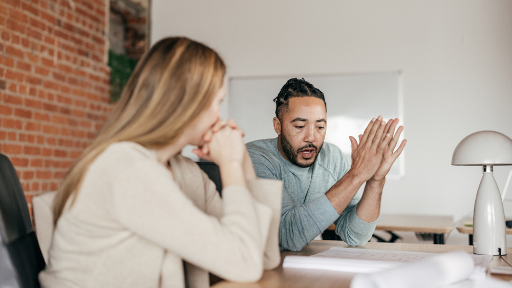 man an woman having important conversation at work