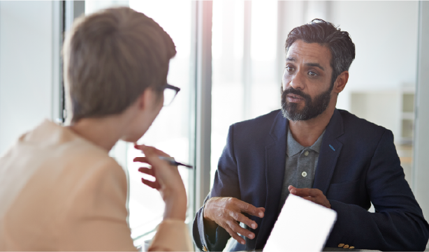 man and woman talking in business office