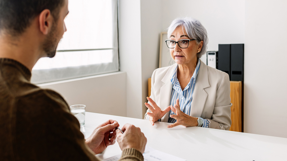 woman and man having a Crucial Conversation in office setting