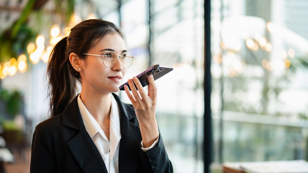 woman talking to AI agent on smartphone