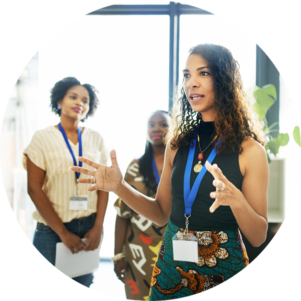 Female speaking to a a group of participants