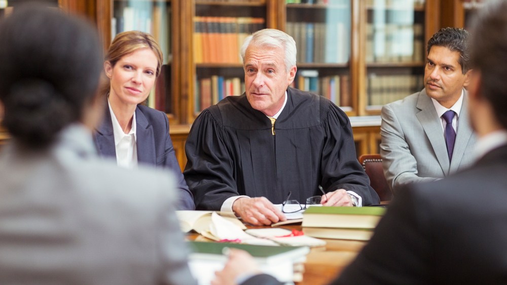 Judge talking with lawyers in chambers