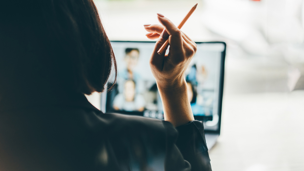 woman watching screen of online meeting