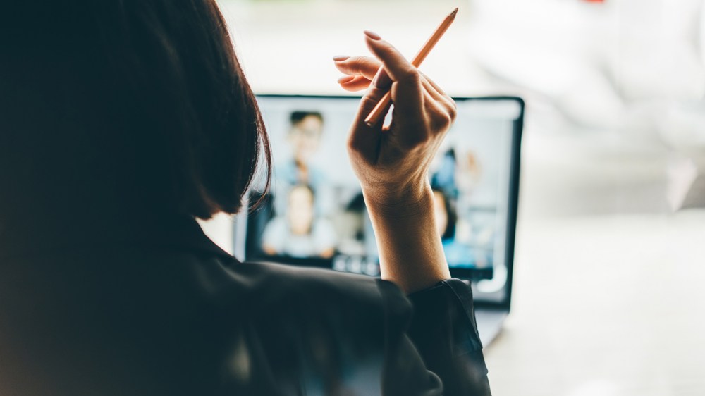 woman watching screen of online meeting
