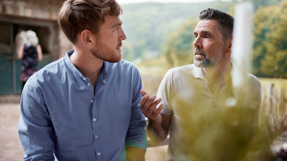 two men talking outside